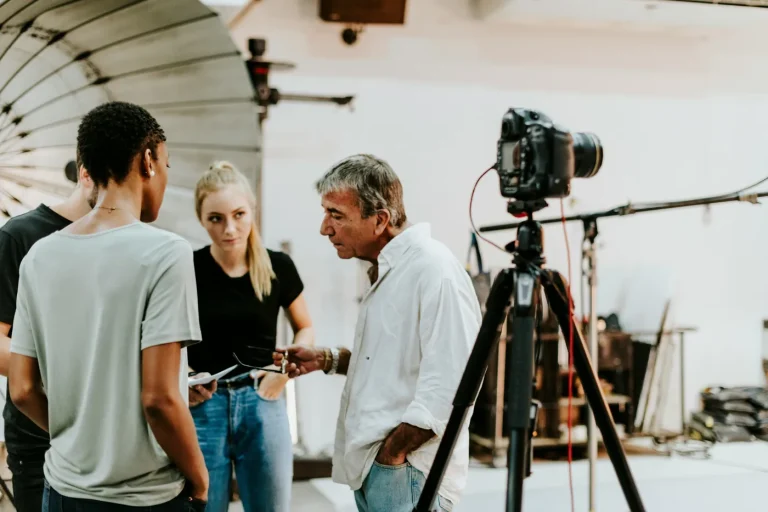 Group and camera in a bright studio.