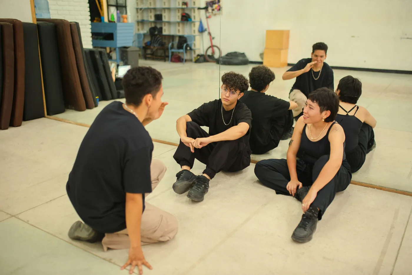 Group seated on a studio floor.